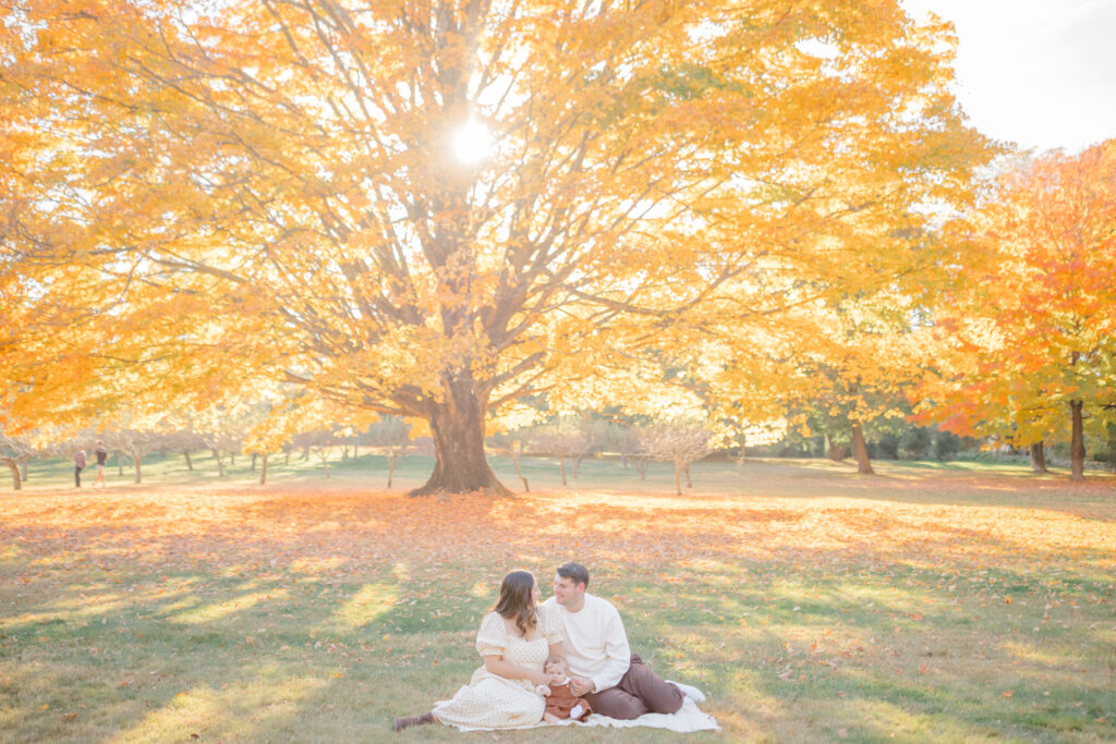 fall family photos with a woman and man and 9 month old 