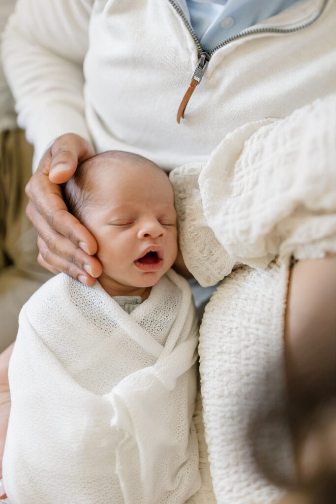 newborn laying with his parents in branford ct
