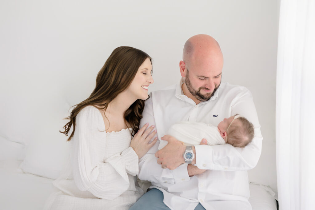 Parent hands gently cradling a newborn during a Fairfield County CT newborn photography session