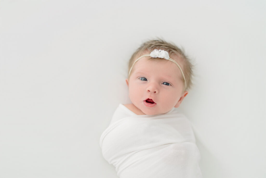 Baby peacefully sleeping on a textured backdrop at a newborn photoshoot in Fairfield County CT