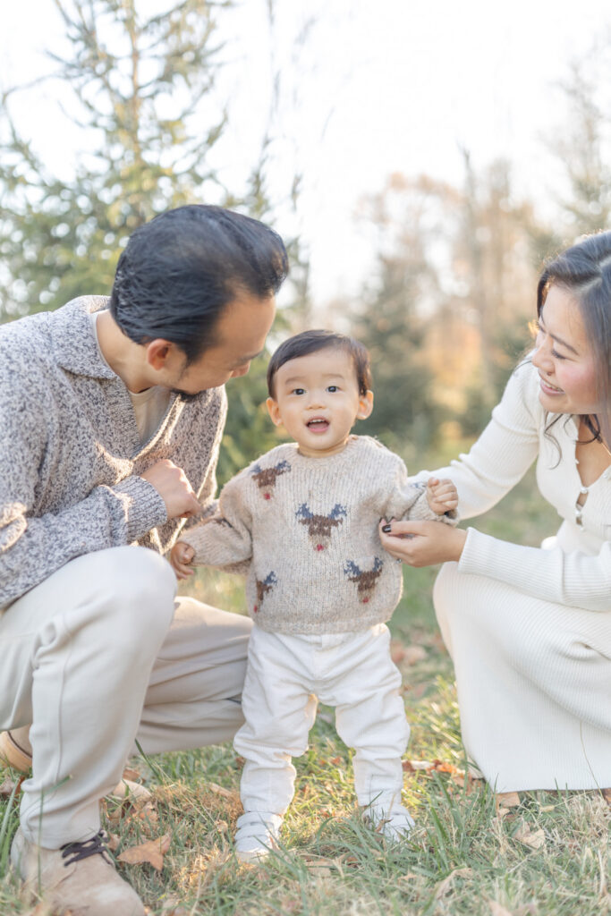 Parents and children sharing a joyful moment at a Christmas tree farm