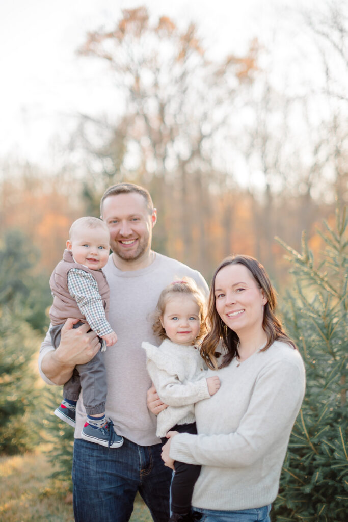 Children in cozy sweaters during a Christmas tree farm mini session