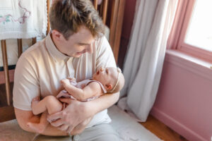 Newborn photographer in Guilford CT capturing parents cuddling their baby