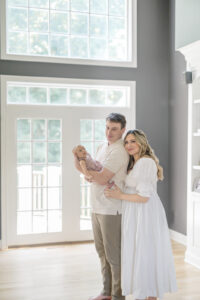 Mom and dad holding their newborn during a newborn photoshoot in Milford CT