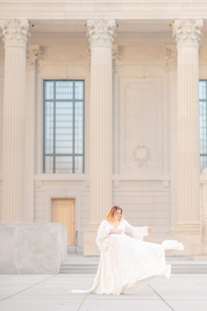 pregnant women in maternity white dress at yale old campus in winter