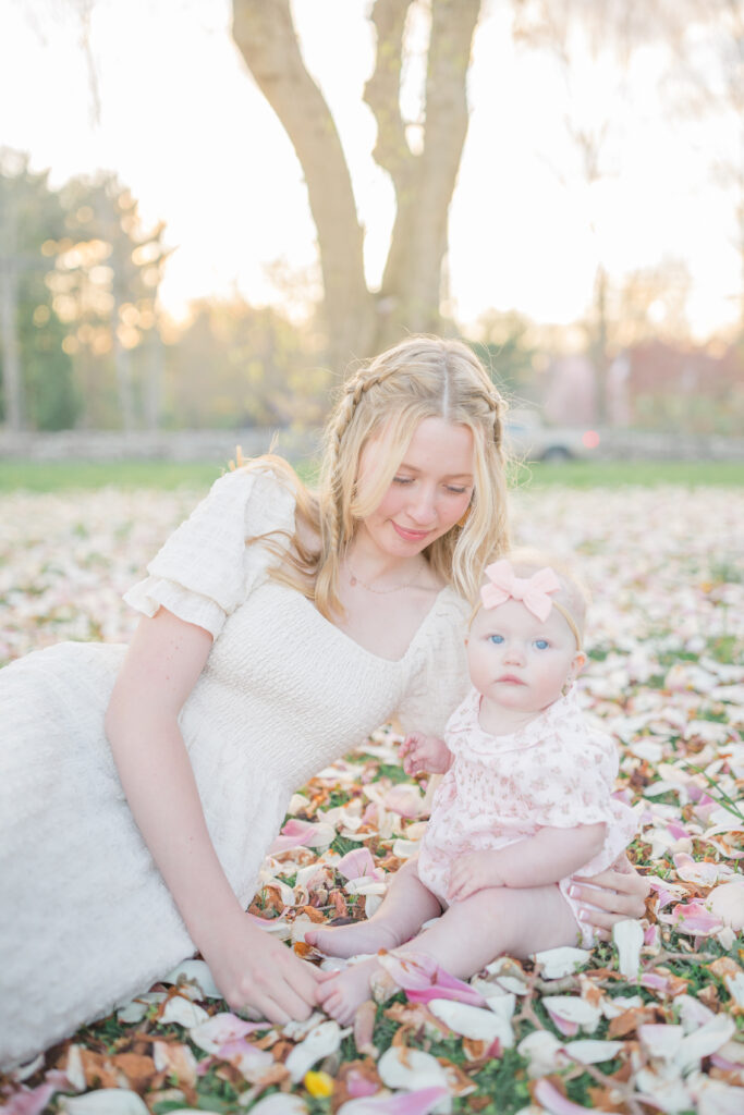 mom and daughter laying in the flowers during spring